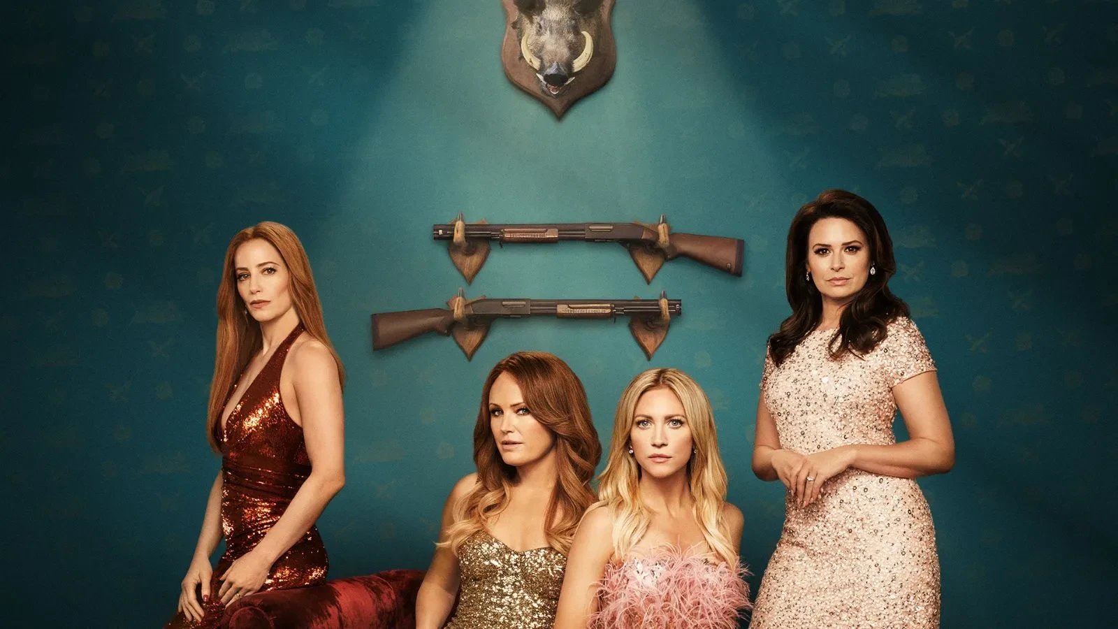 Four women wearing dresses with two stood and two sat against a blue wall with two hunting rifles in the drama Hunting Wives