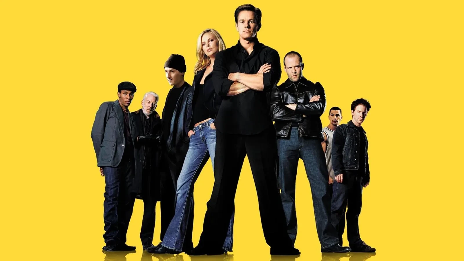 6 men and one women wearing black looking intently at the camera against a block yellow background