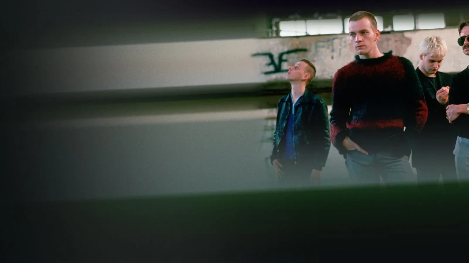 3 young men in the corner of the image with the rest of the image blurred to look like a passing train in the film Trainspotting