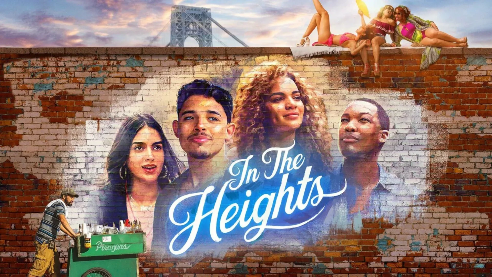 Poster image for the 2021 film In the Heights, featuring a colourful mural painted on a brick wall with the film title in bold white script. The mural shows several characters, and above the wall, two people lounge in bright summer outfits. In the background, part of a suspension bridge is visible, and a man stands at a green cart labelled “Piraguas” in the foreground.