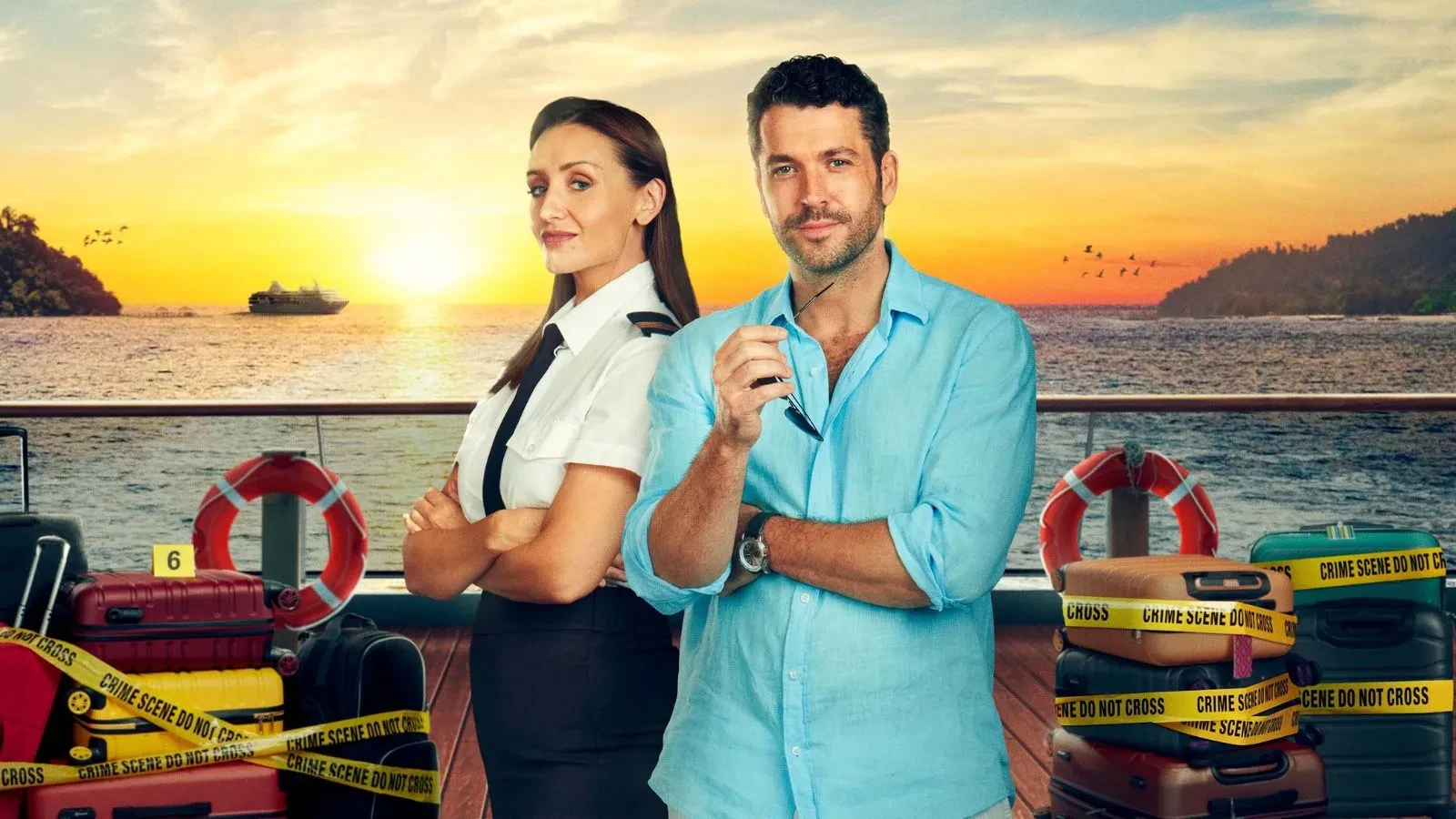 Promotional image from series 3 of the British crime drama The Good Ship Murder, showing two people standing on a ship’s deck at sunset. One is wearing a cruise uniform, and the other is dressed in a light blue shirt holding sunglasses. Around them are suitcases wrapped in yellow crime scene tape, with lifebuoys and the sea in the background.