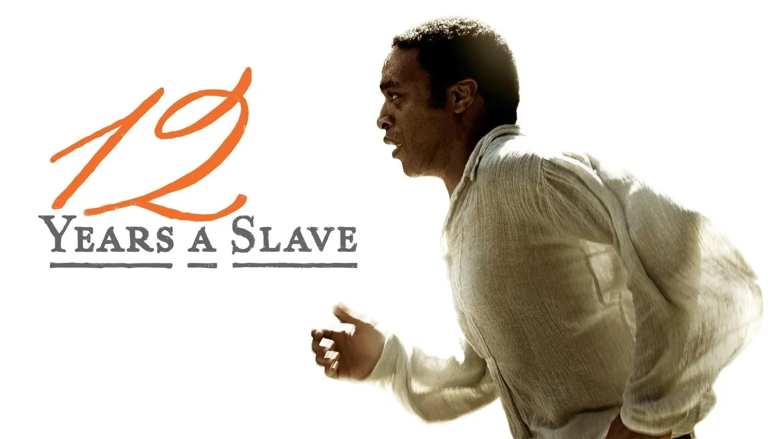 Promotional poster for the film 12 Years a Slave featuring a man in a loose, light-coloured shirt running against a white background, with the movie title in bold grey text and an orange handwritten-style number 12