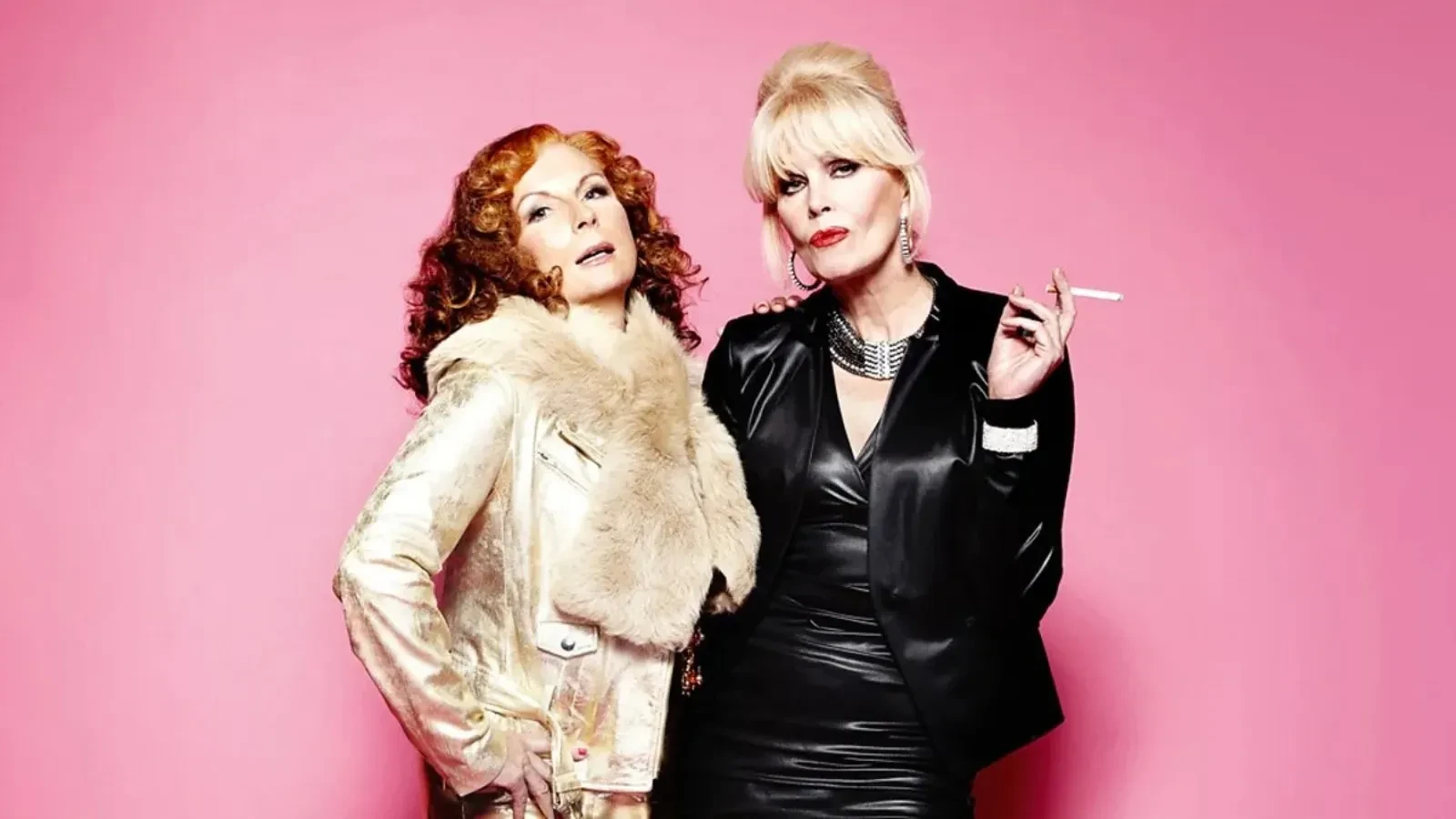 Two stylish women posing confidently against a bright pink backdrop, one wearing a glamorous fur‑trimmed metallic jacket and the other dressed in a sleek black outfit while holding a cigarette, creating a bold, fashionable and satirical glamour aesthetic.