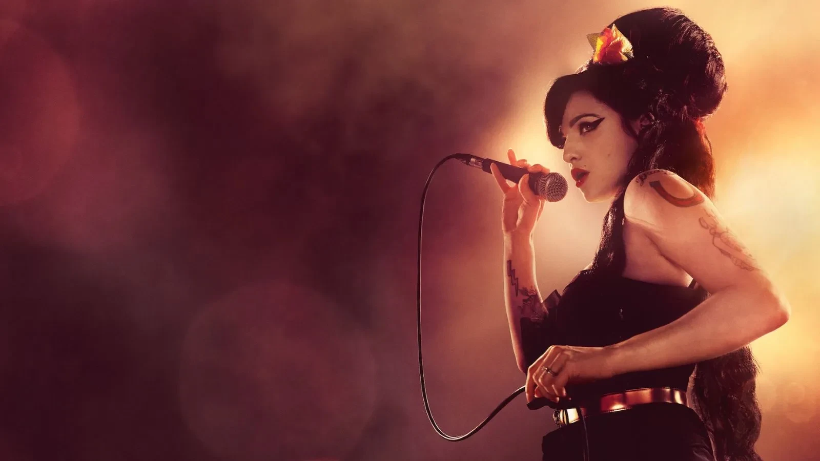 Poster image showing a female singer performing on stage, holding a microphone under warm spotlight lighting, with dramatic makeup and a beehive hairstyle.
