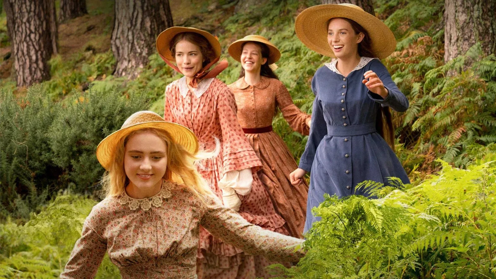 Four people wearing long, old-fashioned dresses and wide-brimmed straw hats walk through a green forest with ferns and tall trees.