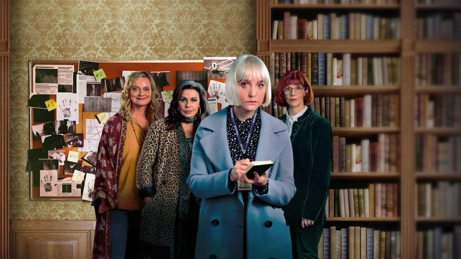 A group of women stands in front of a detailed investigation board filled with photos, notes, and evidence, set against a cosy library backdrop.