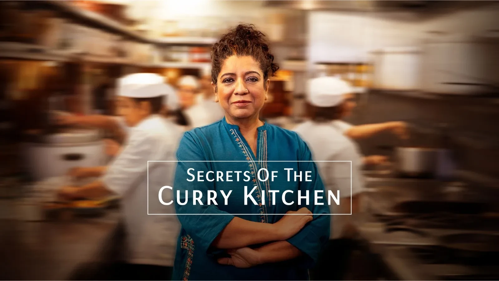 Promotional image for “Secrets of the Curry Kitchen” featuring a person in a blue traditional tunic standing confidently with arms crossed in a busy professional kitchen, with chefs cooking in the blurred background.