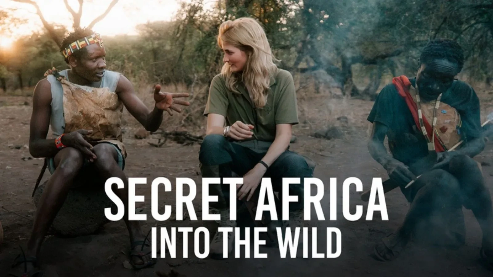 Traveller seated outdoors with local guides in a forest setting, featured in ‘Secret Africa: Into the Wild’ documentary.