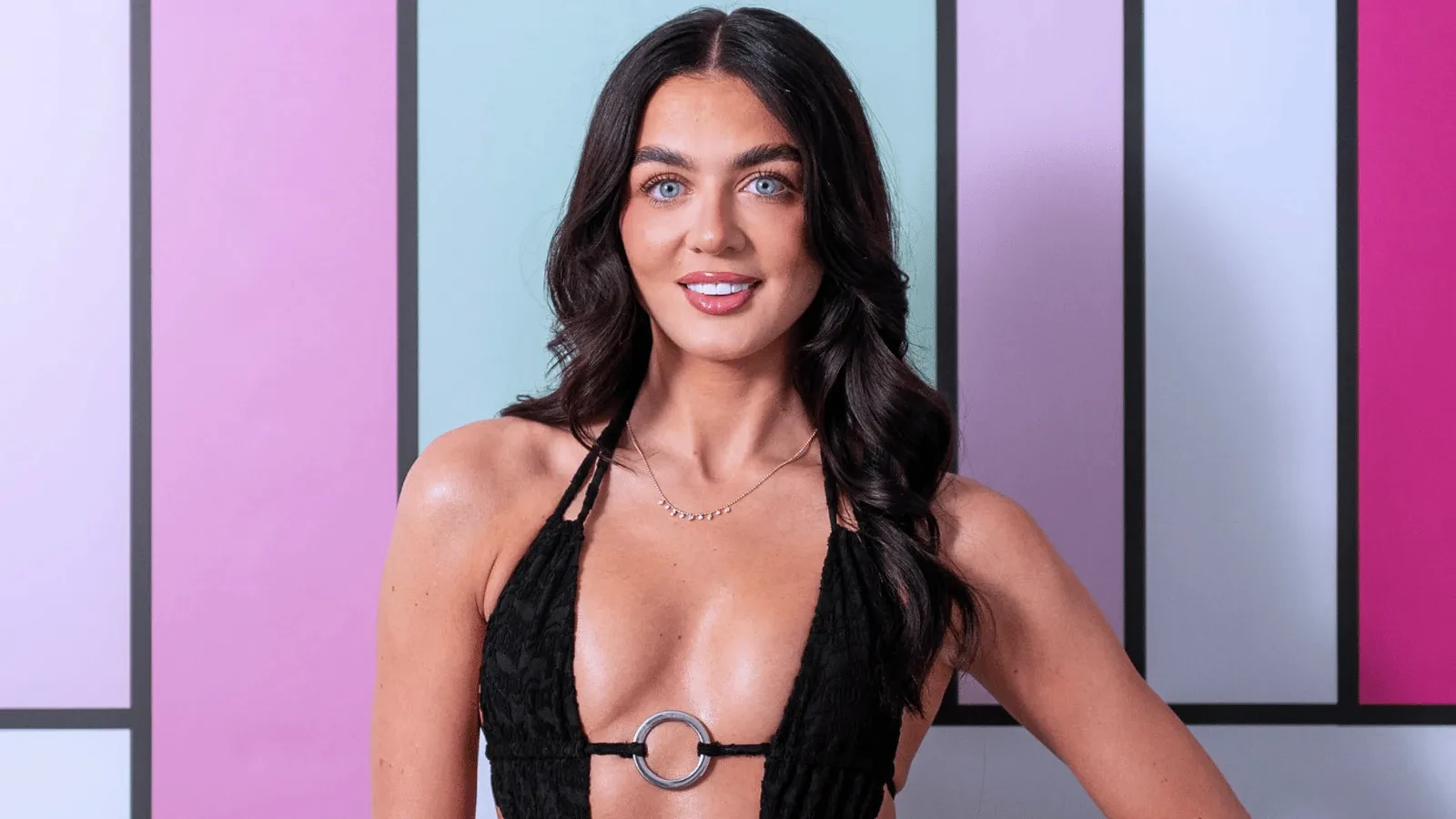 Olivia Sanderson stood against the colourful Love Island Backdrop