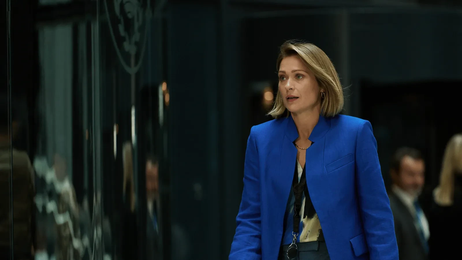 Government representative walks through a secure operations centre coordinating responses to a major cyberattack in The Undeclared War.