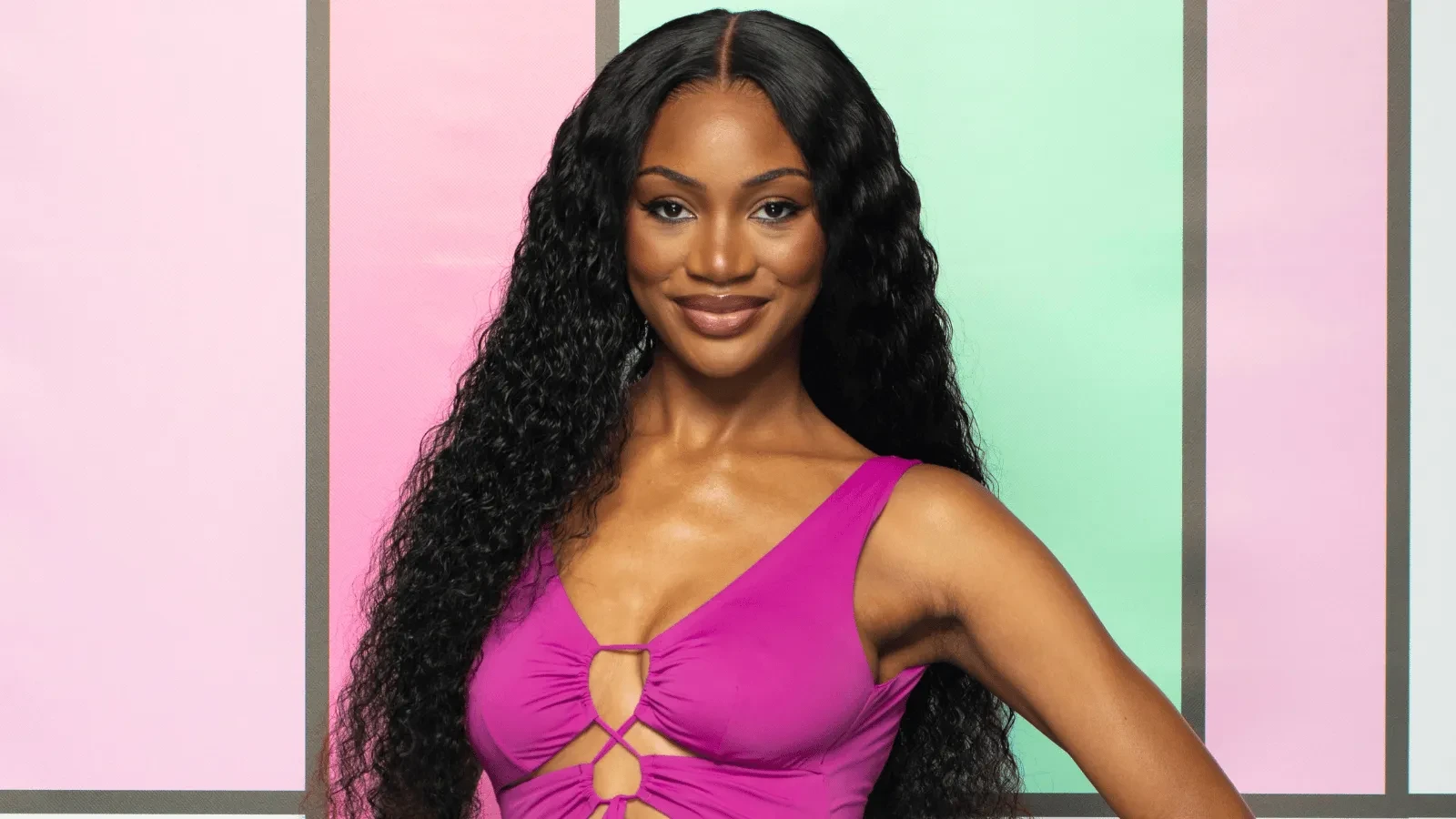 Victoria Onanusi stood against the colourful Love Island Backdrop